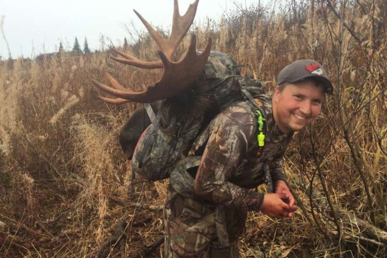 hunter-back-packing-moose